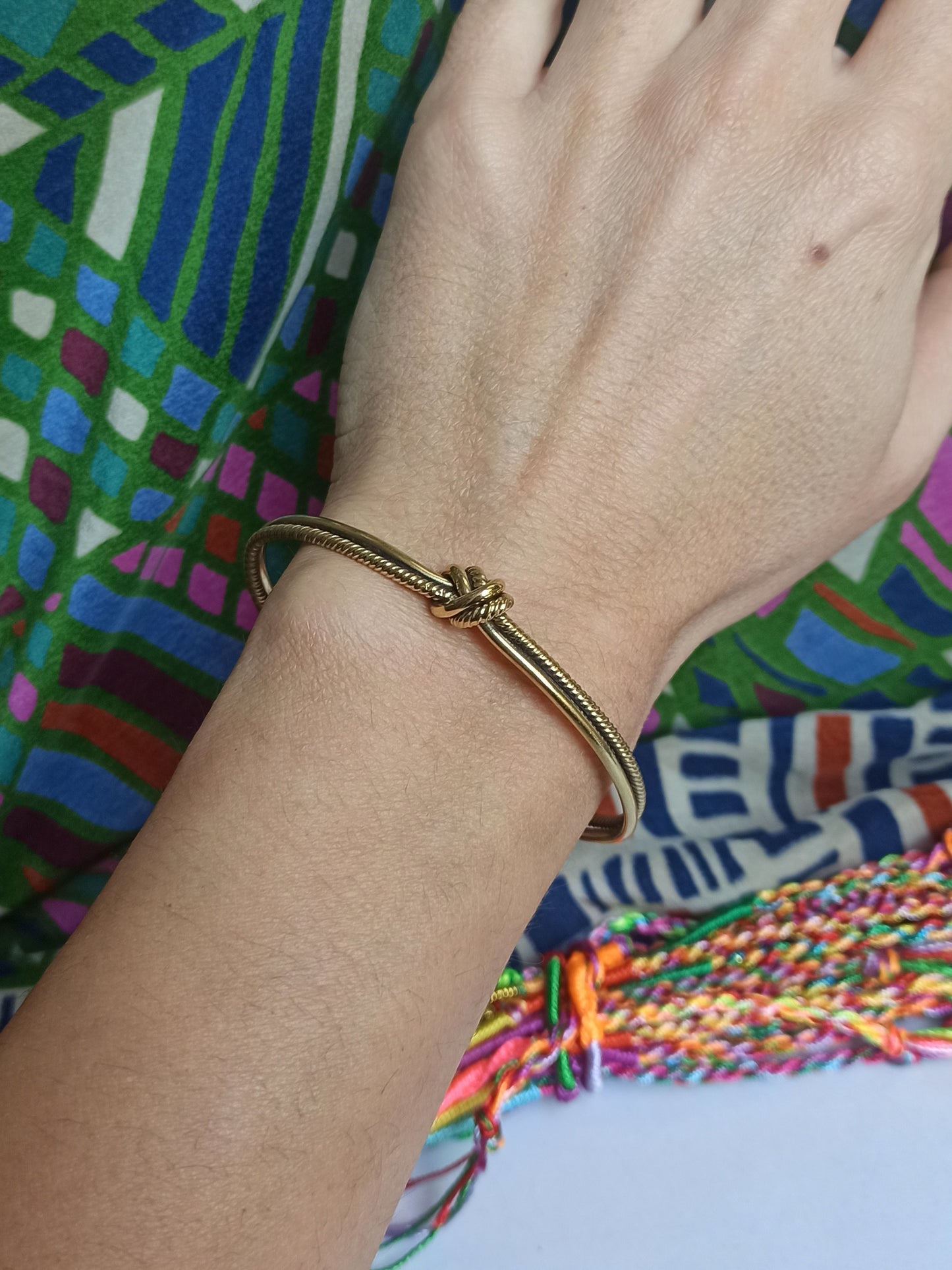 Thin golden knot bangle bracelet