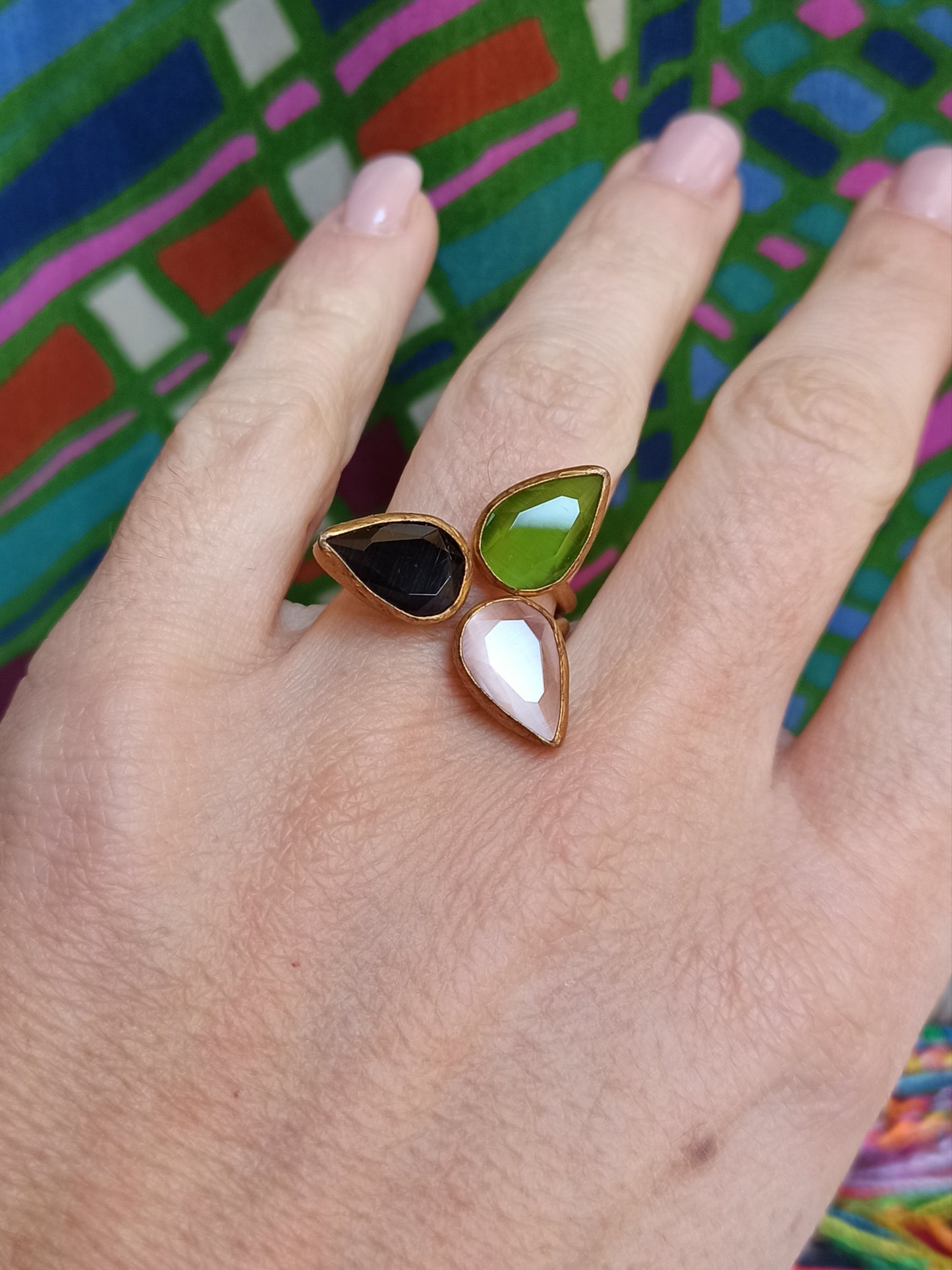 Golden ring with 3 green, pink and black drops