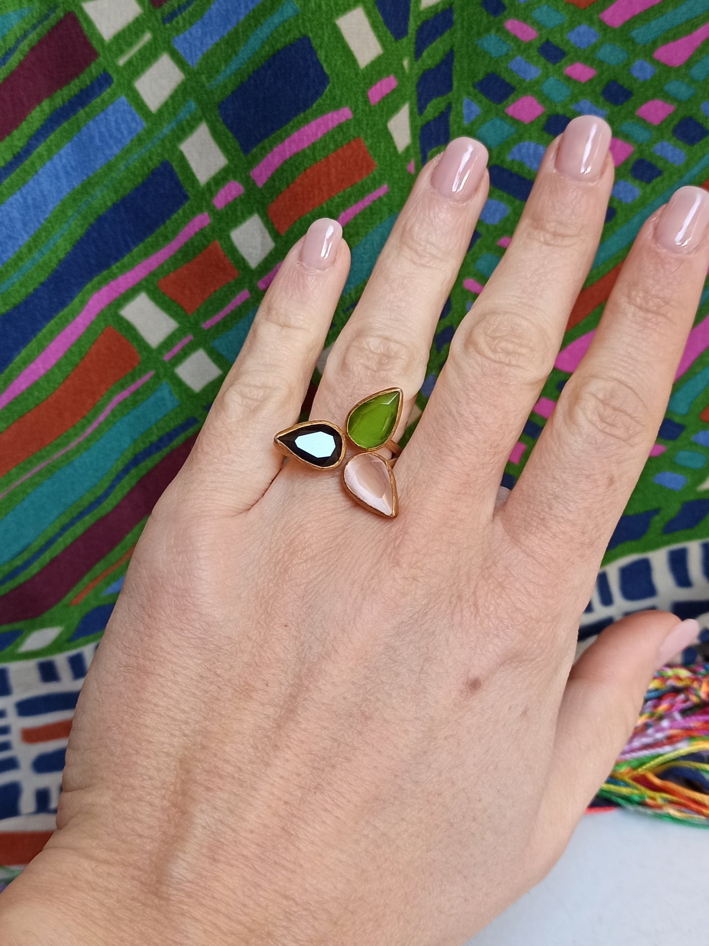 Golden ring with 3 green, pink and black drops