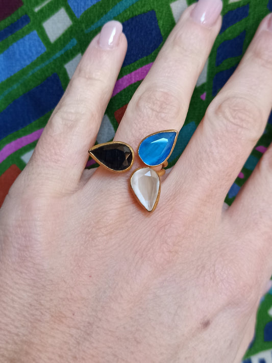 Golden ring with 3 drops, blue, white and black