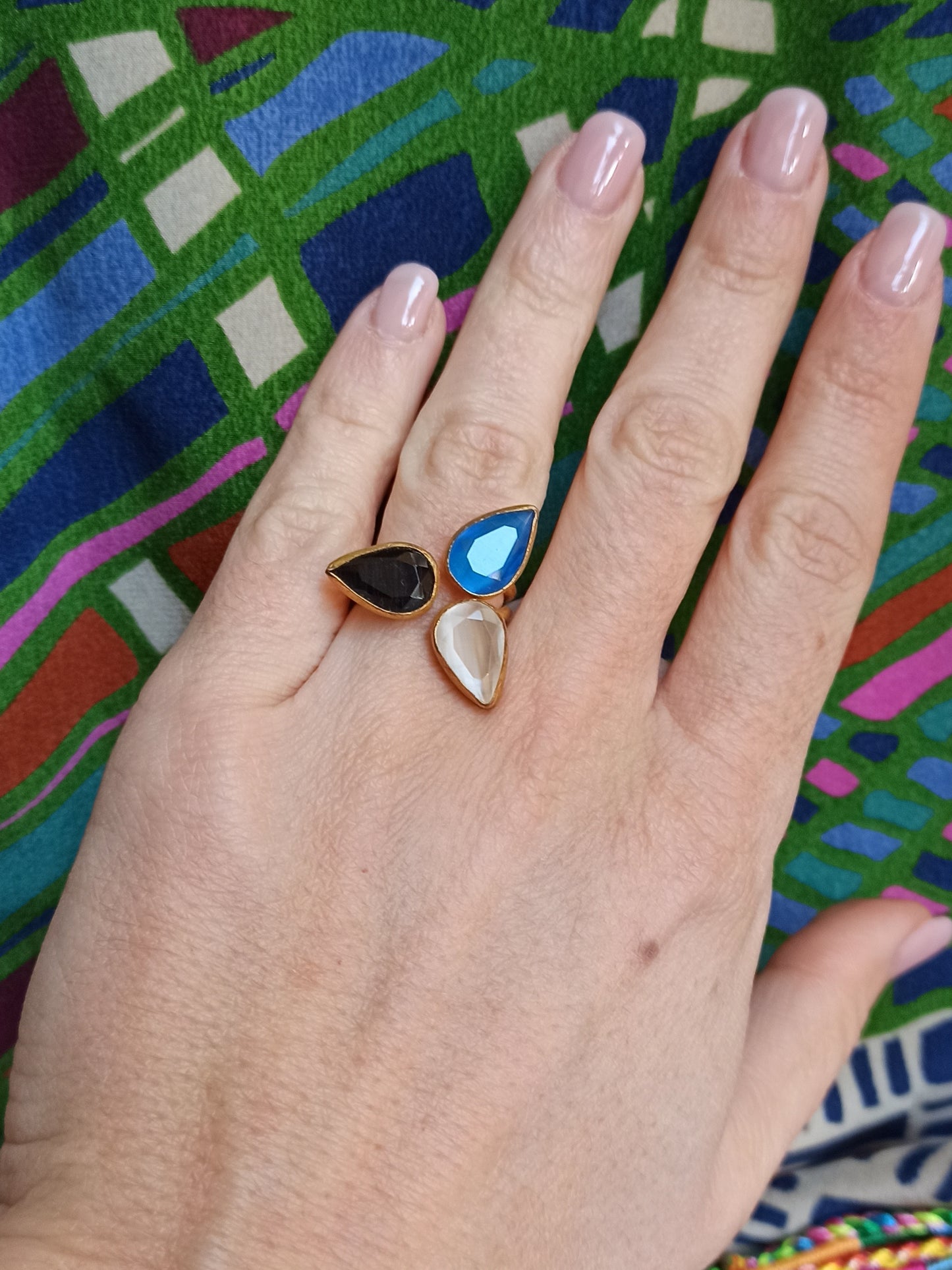 Golden ring with 3 drops, blue, white and black