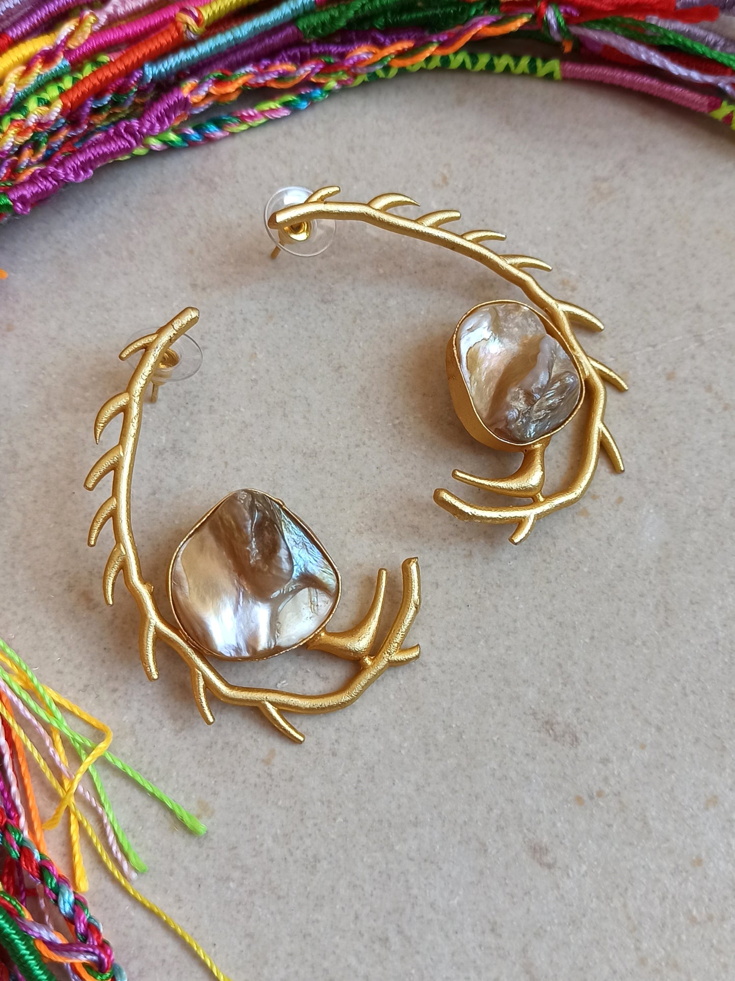 Stylized mother of pearl golden earrings