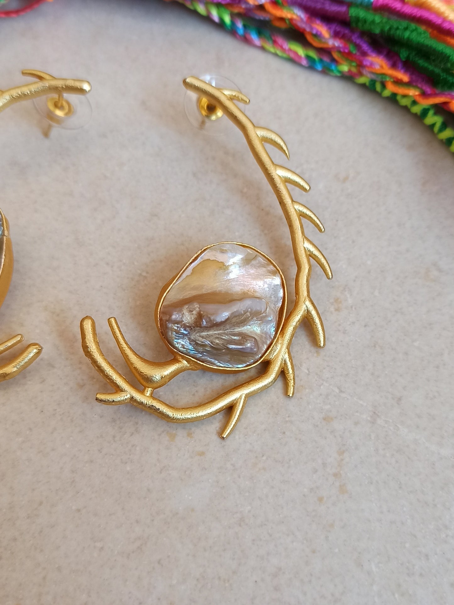 Stylized mother of pearl golden earrings