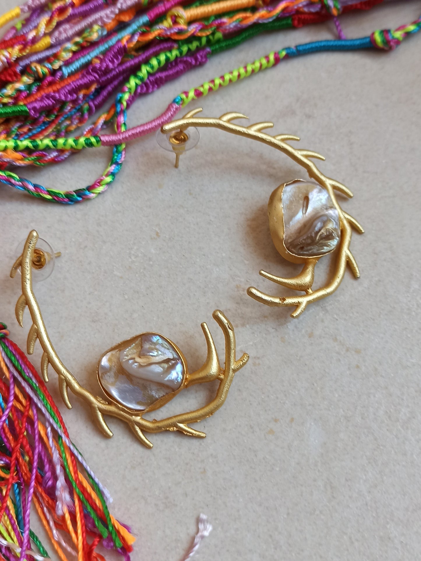 Stylized mother of pearl golden earrings