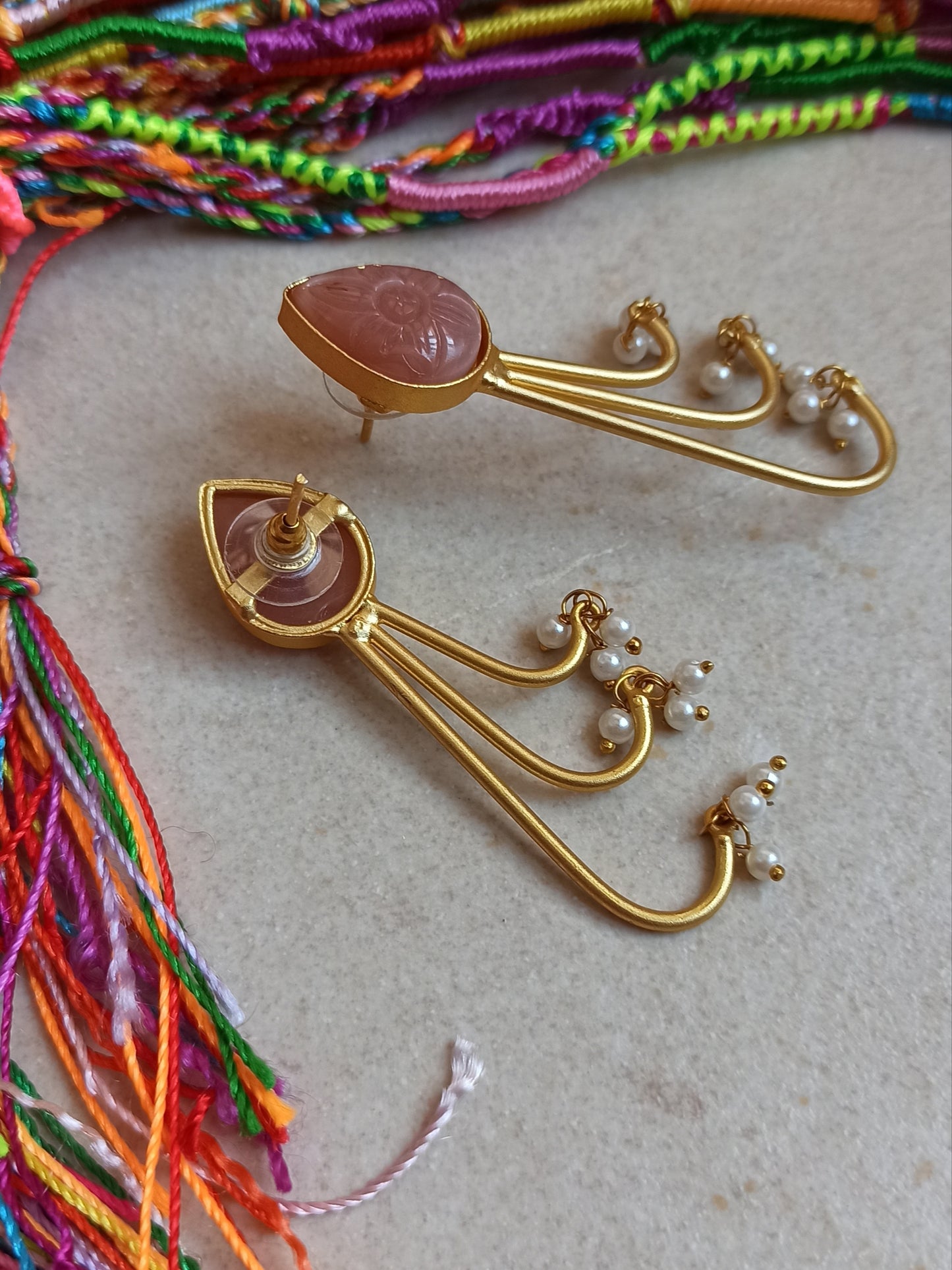 Pink dangling golden earrings