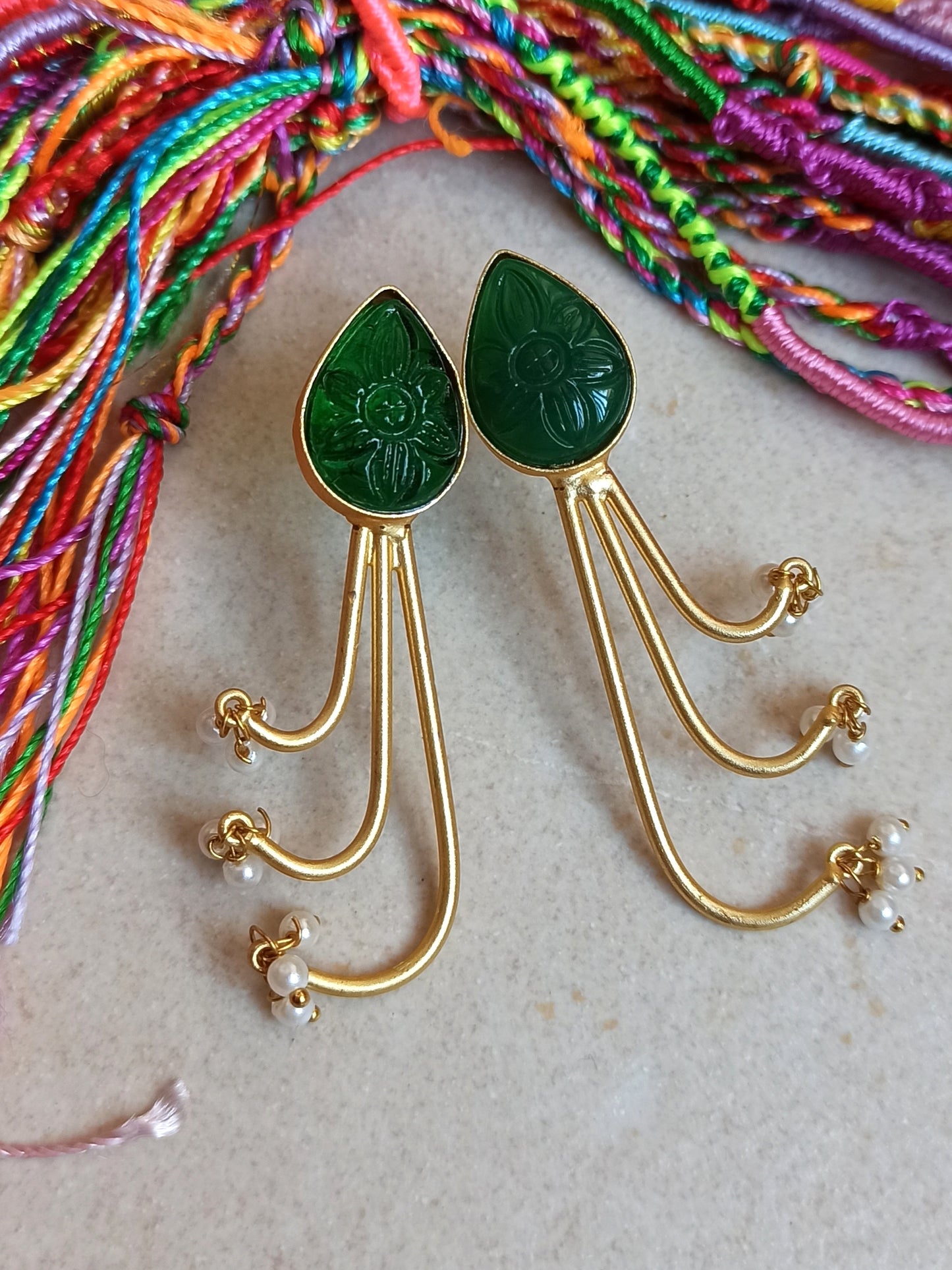 Green dangling golden earrings