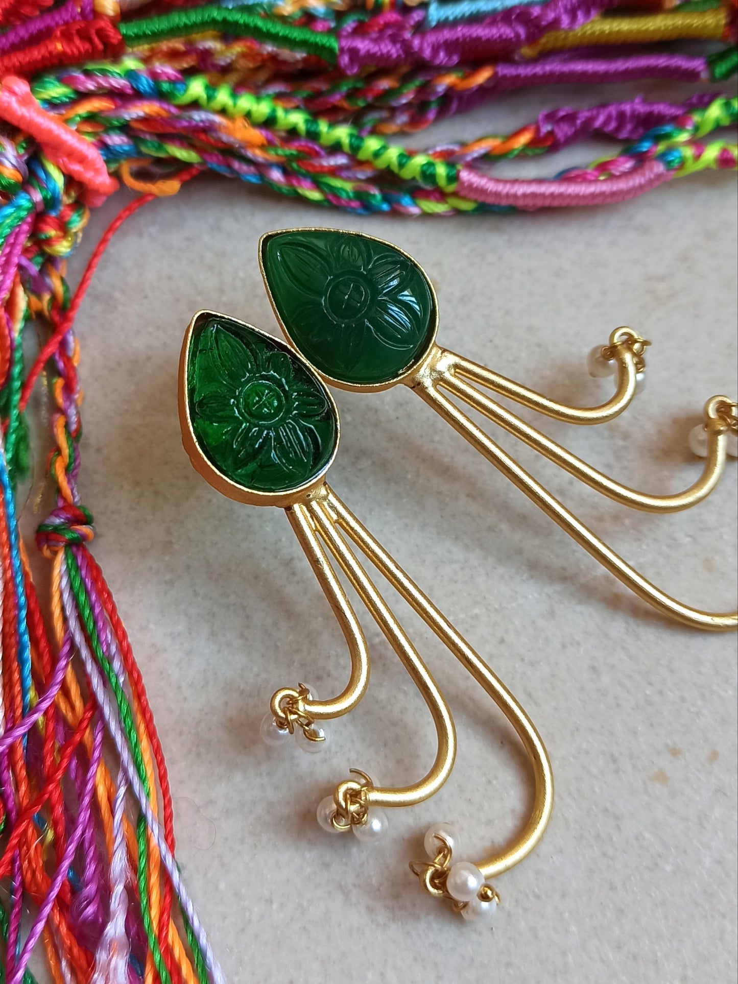 Green dangling golden earrings