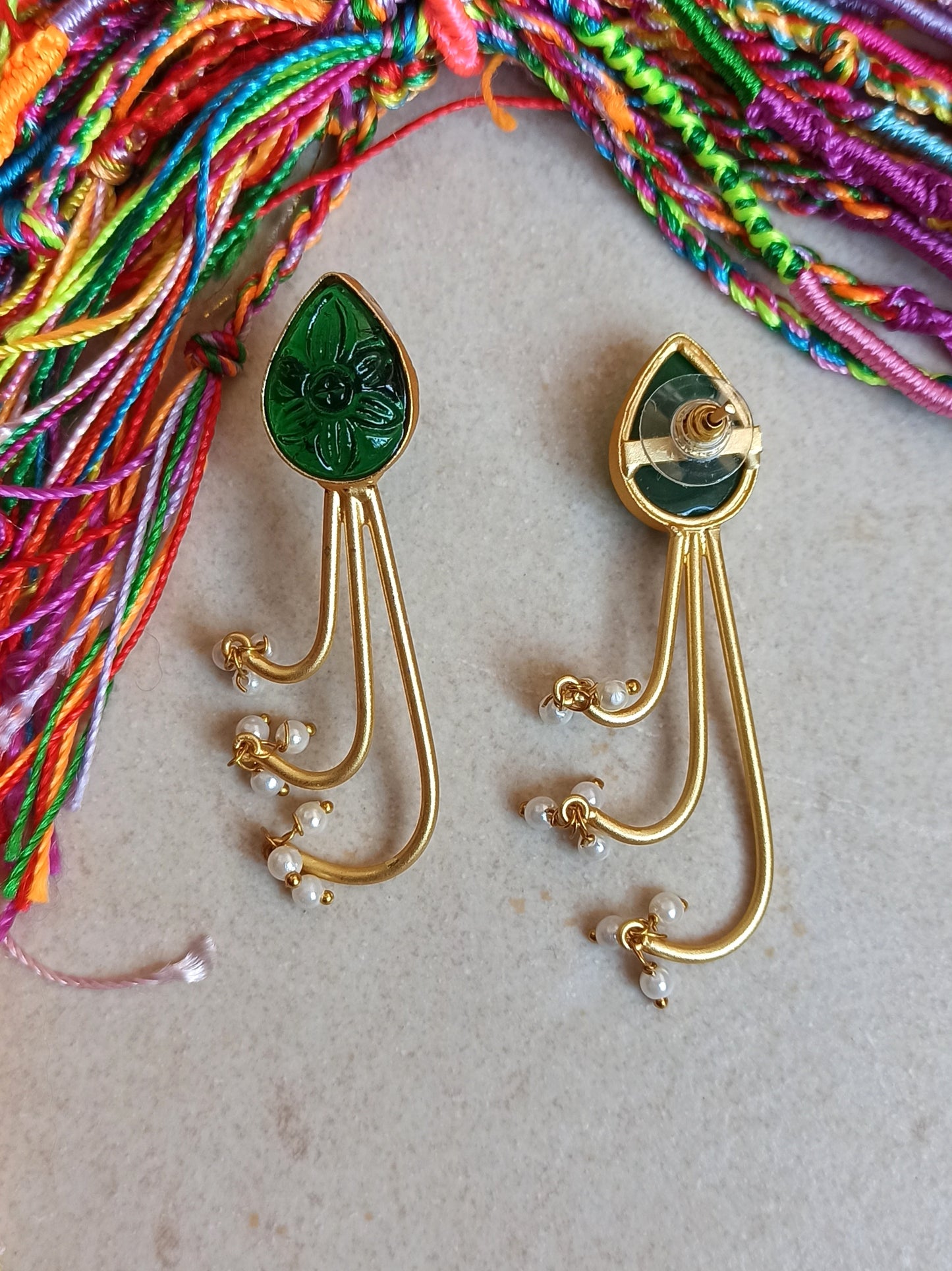 Green dangling golden earrings