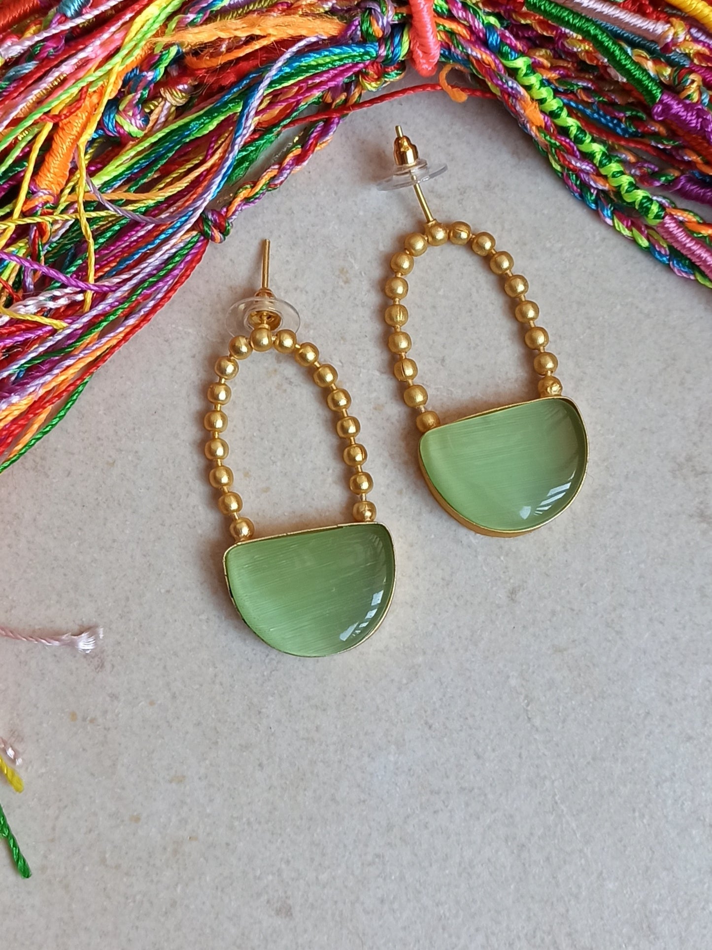 Green dangling golden earrings