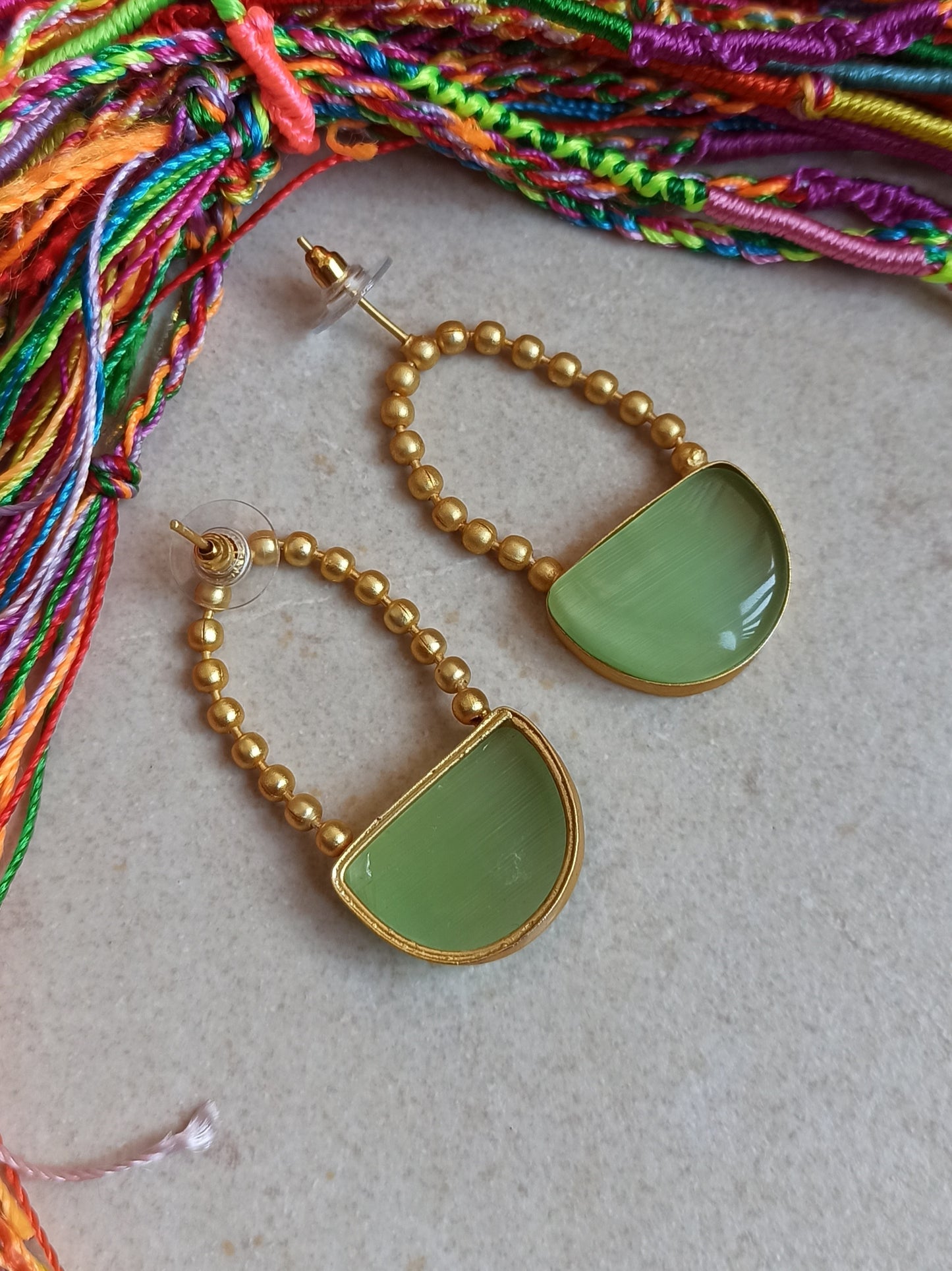 Green dangling golden earrings