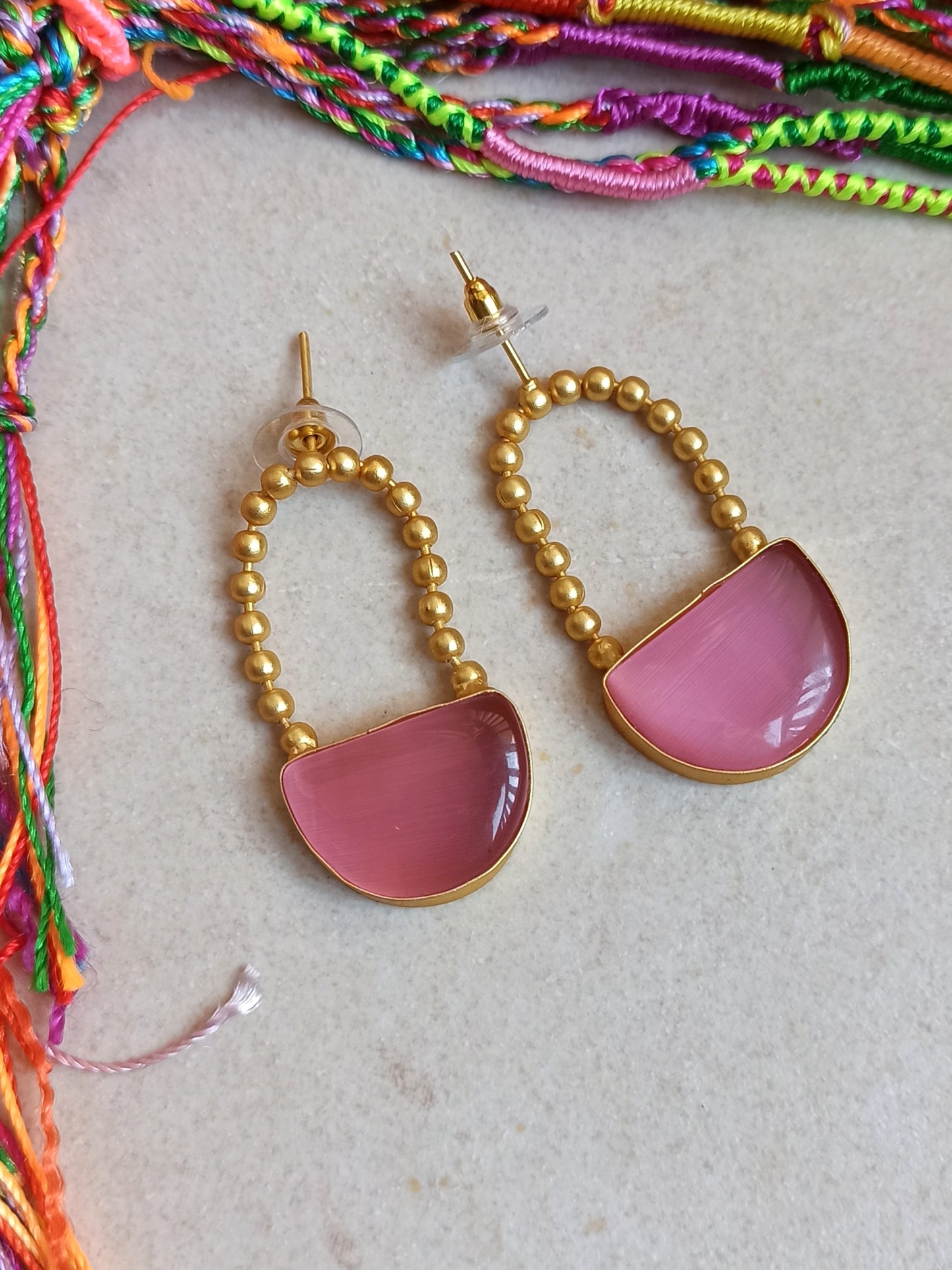 Pink dangling golden earrings