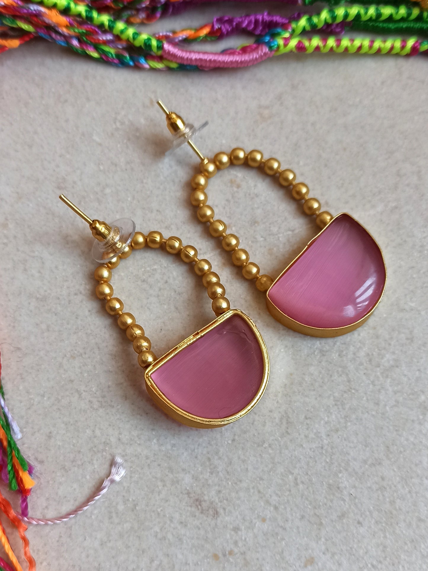 Pink dangling golden earrings