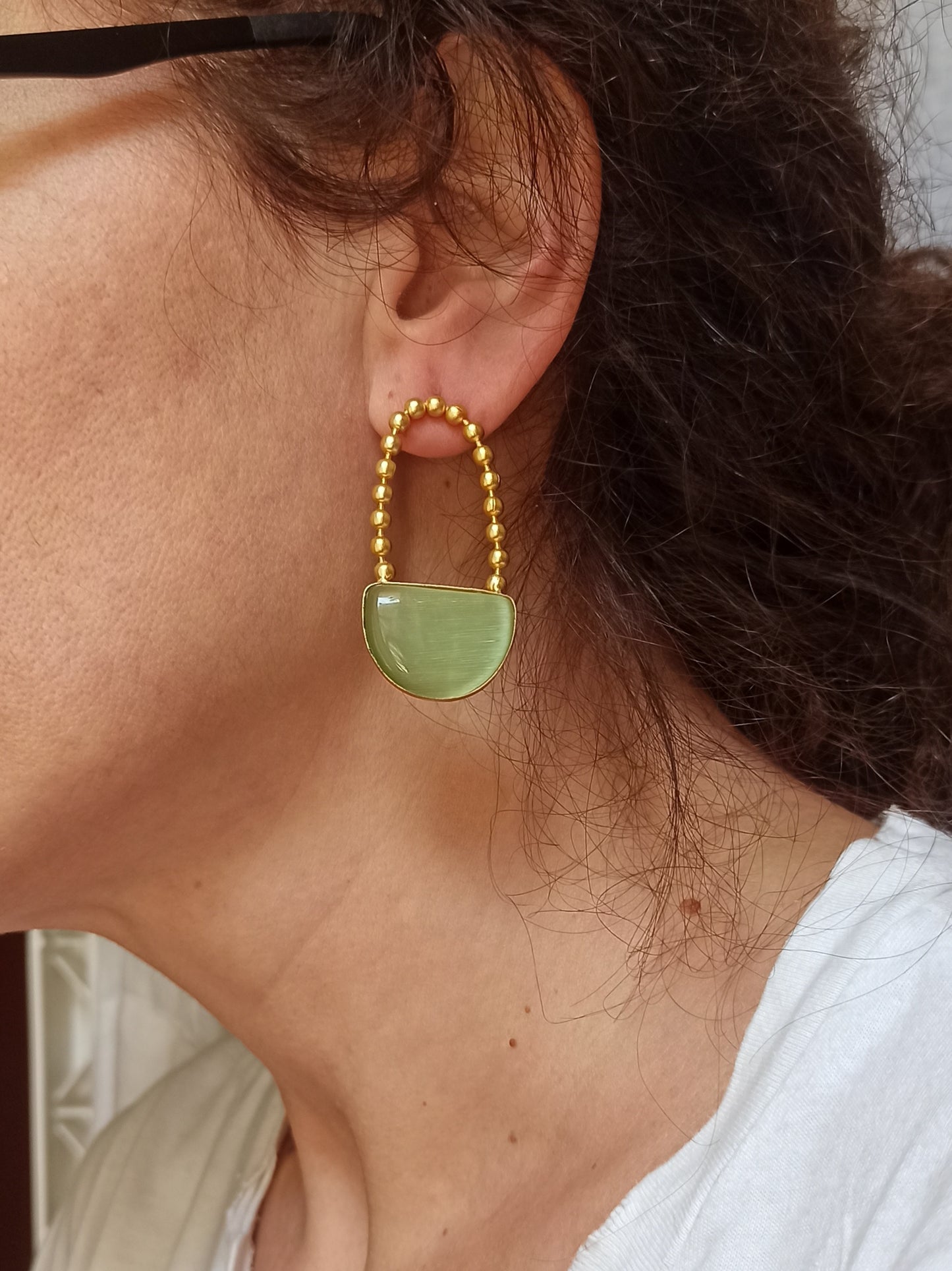 Green dangling golden earrings